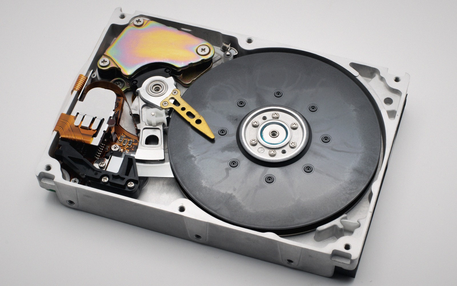 an opened hard drive with platters and head arm visible
